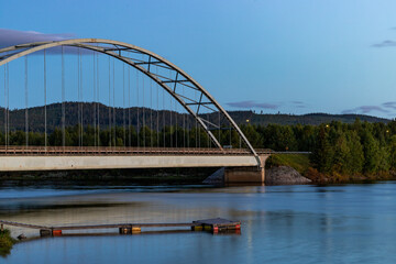Fototapeta na wymiar Sorsele, Sweden A steel arch bridge over the Vindelalven river.