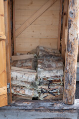 Sorsele, Sweden Stacks of firewood for sale from a small wooden cupboard at a market.