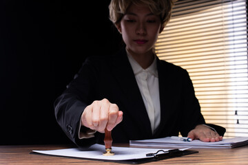 Person Signing Approval document, certificate, legal agreement in office by pen and stamp hand....
