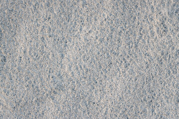 White sand texture with rugged surface close up top view