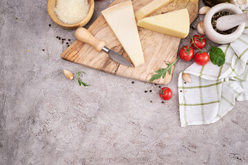 Fototapeta na wymiar Parmesan cheese and knife on a wooden cutting board