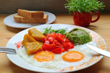 Delectable breakfast dish of sunny-side up with colorful vegetable salad