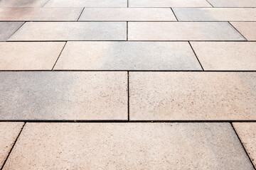 The space is paved with large long concrete slabs. Diminishing perspective. Selective focusing.