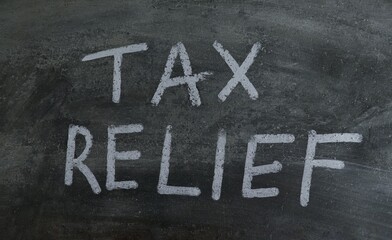 Tax Relief Words Written on Blackboard with White Chalk