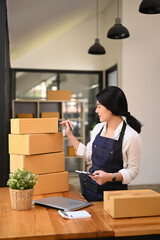 Small business entrepreneur preparing parcel boxes of product for delivery to costumer. Online selling, e-commerce concept