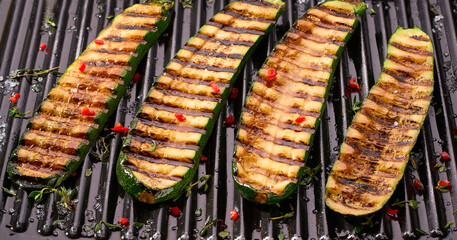 Delicious sliced grilled zucchini with herbs and salt.