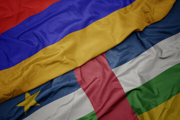 waving colorful flag of central african republic and national flag of armenia.