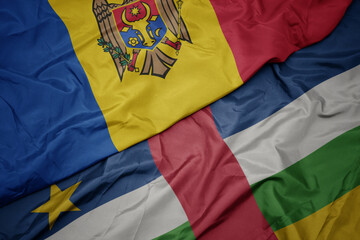 waving colorful flag of central african republic and national flag of moldova.