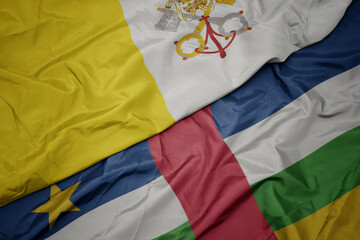 waving colorful flag of central african republic and national flag of vatican city.