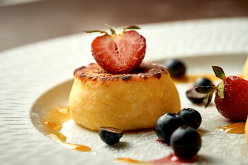 Ukrainian syrniki with jam and berries. Selective focus, close-up