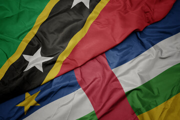 waving colorful flag of central african republic and national flag of saint kitts and nevis.