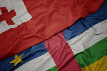 waving colorful flag of central african republic and national flag of Tonga .