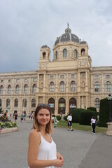 Obraz premium a young European-looking girl poses on Maria Theresa Square in Vienna