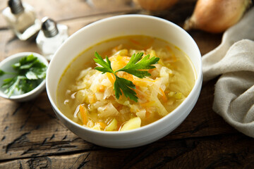 Traditional homemade sauerkraut soup with fresh parsley