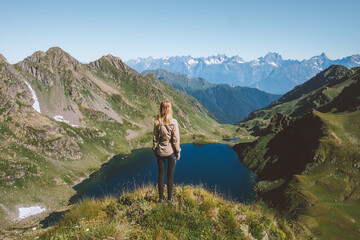 Woman on mountain top enjoying lake view hiking travel adventure outdoor healthy lifestyle summer vacations activity trip