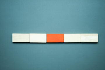 A row of empty four wood block rectangle shape with one orange wood block in the middle