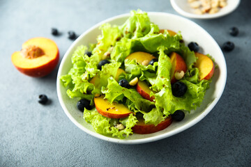 Healthy leaf salad with peach and blueberry
