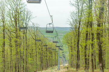 The city of Goryachy Klyuch, chairlifts in the forest. A cable car for climbing to the top of the mountain without people.