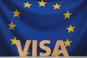 Word Visa made of wooden letters on table against European Union flag. Space for text