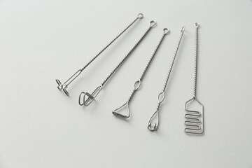 Set of logopedic probes for speech therapy on light grey background, above view