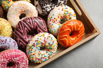 Yummy donuts with sprinkles in box, closeup