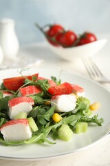 Tasty crab stick salad served on white table, closeup. Space for text