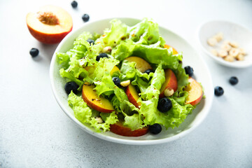 Healthy leaf salad with peach and blueberry