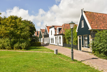 Fototapeta na wymiar Oudeschild, Netherlands. August 2022. The fishermen's cottages of Oudeschild, a village on the island of Texel.