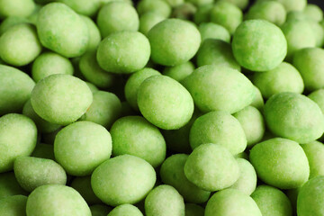 Tasty wasabi coated peanuts as background, closeup