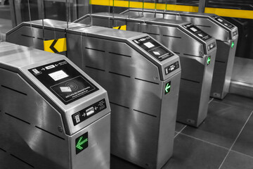 View on metro station ticket barriers with green light for entry. European metro station. Station...