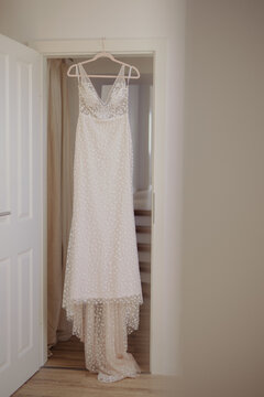 wedding dress hanging on a hanger