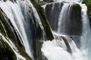 Fototapeta premium a magnificent waterfall called strbacki buk on the beautifully clean and drinking Una river in Bosnia and Herzegovina in the middle of a forest.