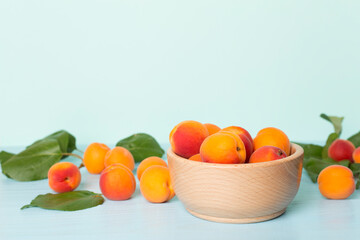 Composition with ripe apricots on wooden table