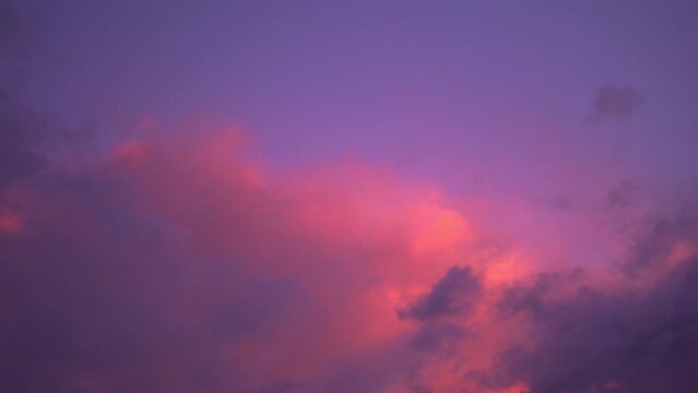 Scenery Pink Cloud In Purple Sky Of Sunset Above The Ocean. .purple Clouds Cover The Ocean During Colorful Cloud In Sunset At Kata Beach Phuket..video 4K. Scene Of Pink Light In The Sky Background.