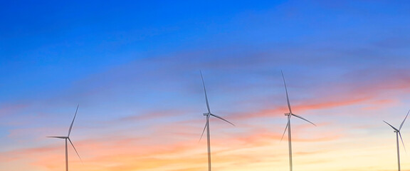 The banner of clean energy sunset scene at  Solar panels with wind turbines generating electricity...