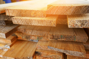 Wooden boards are stacked in a sawmill or carpentry shop. Sawing drying and marketing of wood....
