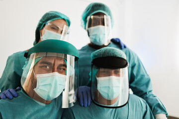 Fototapeta na wymiar Medical doctors working inside laboratory hospital during coronavirus outbreak - Focus on left doctor face