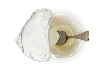 Open plastic glass of yogurt on a white background. Eaten yogurt.