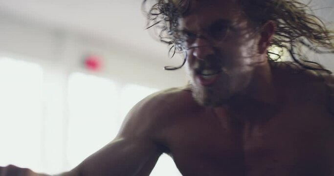 Man doing fitness training on bike at gym, workout for sports motivation and cardio exercise for strong body. Face of person with testosterone getting healthy and moving for wellness and health