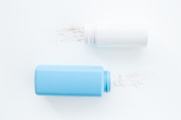 Spilled baby talcum powder in container. Kids skin care cosmetic