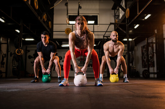 Weightlifting group, kettlebell squat and fitness, exercise class