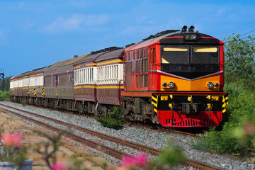 Fototapeta na wymiar Passenger train by diesel locomotive on the railway in Thailand.