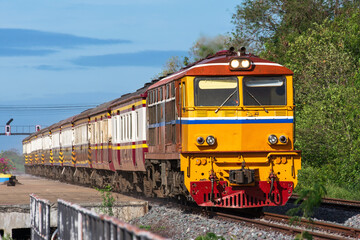 Obraz premium Passenger train by diesel locomotive on the railway in Thailand.