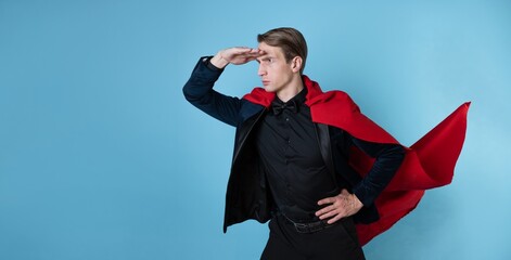 The superhero hurries forward, a man in a business suit and a red cape. charismatic and successful...