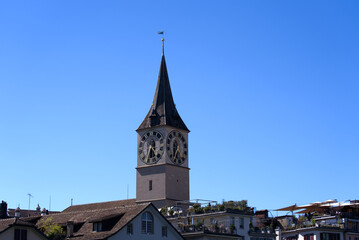 Fototapeta na wymiar Famous St. Peter church at the old town at City of Zürich on a sunny summer day. Photo taken July 2nd, 2022, Zurich, Switzerland.
