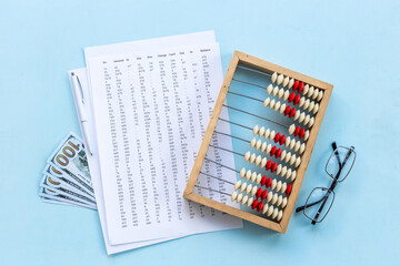 Business income calculations with accounting wooden abacus