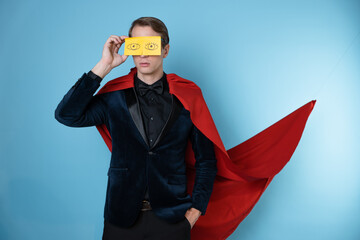Sleep problems due to overwork. A man in a business suit and a red cape like a superhero with...
