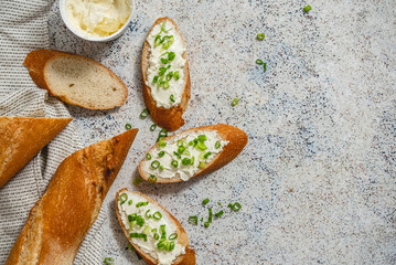 Fresh and delicious crispy baguette with cream cheese and chives - obrazy, fototapety, plakaty