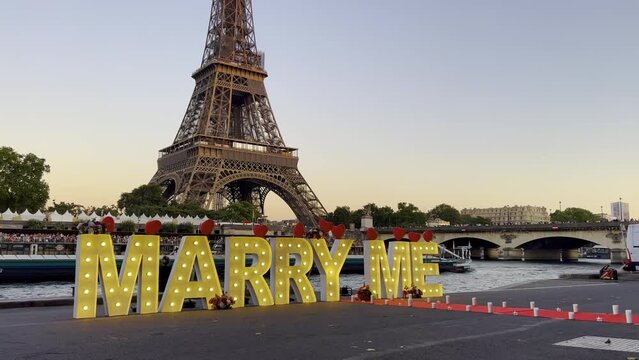 Cinematic shot man making surprise proposal of marriage to his beloved woman near eiffel tower with lighting while enjoying together romantic trip in Paris
