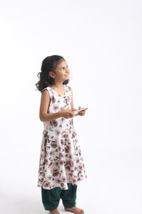 Cute indian little girl using smartphone on white background.